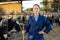 Experienced female farmer standing with pitchfork in livestock farm