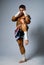 An experienced fighter kickboxer kick. full height