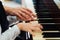 Experienced hand of old music teacher helps child pupil