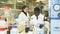 Experienced male and female scientists standing in interior of laboratory