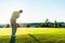 Experienced male golfer hitting the golf ball towards the cup