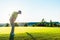 Experienced male golfer hitting the golf ball towards the cup du