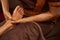 Experienced masseuse giving her client relaxing Thai foot massage