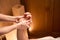 Experienced massotherapist giving hand massage to spa salon customer