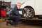 Experienced mechanic makes a wheel alignment