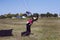 An experienced parachutist landed successfully and pulls the slings with a parachute