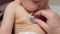 Experienced pediatrician checks lungs of newborn baby girl