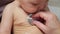 Experienced pediatrician checks lungs of newborn baby girl