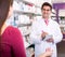 Experienced pharmacist counseling female customer