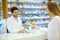 Experienced pharmacist counseling female customer