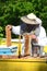 Experienced senior apiarist cutting out piece of larva honeycomb in apiary