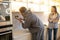 Experienced serviceman installing the outlet on the kitchen wall