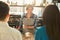 Experienced smiling barista making coffee to customers