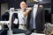 Experienced tailor tries on a new jacket on a mannequin in workshop