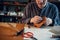 An experienced tanner sews a clasp for a leather product with stitches