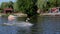 An experienced wakeboarder makes a jump. Athlete during wakesurfing on the lake at the cable wake park.