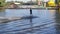 An experienced wakeboarder makes a jump. Athlete during wakesurfing on the lake at the cable wake park.