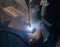 An experienced welder at work. Preparation and welding process of cast iron furnace. Selection focus. Shallow depth of field