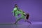Experimental dance. Two young girl in motion, action  over purple background. Emotions, love, style, youth
