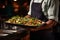 Expert food stylist meticulously decorating a delicious meal for impeccable restaurant presentation