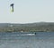 Expert Kitesurfer Planing with  Sea Watrer Splashes during Golden Hour