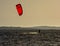Expert Kitesurfer Planing with  Sea Watrer Splashes during Golden Hour