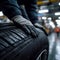 Expert mechanic Holding tire, repairing car, skilled auto repair indoors