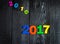 Expiring 2016.New year 2017,colorful figures on the wooden background.