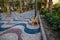 Explanada promenade in Alicante Spain landmark with wooden empty chair on mosaic