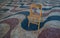 Explanada promenade in Alicante Spain landmark with wooden empty chair on mosaic
