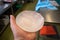 The explanted silicone breast implant lies in one hand