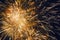 Exploding golgen bright fireworks against a Night Sky