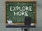 Explore More - Hand Drawn on Green Chalkboard. 3D