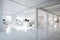 Explore an open and uncluttered office space featuring white walls and floors, promoting a calm and focused work environment,