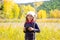 Explorer binocuar kid girl in yellow autumn nature