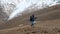 Explorer Female with Backpack Hiking in Mountains