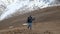 Explorer Woman with Backpack Hiking in Mountains