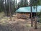 Exploring a log cabin during a kamloops wilderness hike