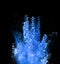 Explosion of blue powder on black background