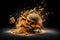 Explosion of a large hamburger on a dark background