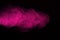 The explosion of pink powder. Freeze motion of color powder exploding isolate on black background.