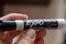 Expo Dry Erase marker, black, with hand holding for whiteboards. Mistakes, remove, education concepts