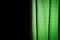 Exposed green curtain on a black background