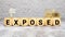 EXPOSED word made with building blocks, concept