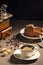 Exposition of chocolate cake with cup a coffee, coffee grinder on background. Black background.