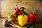 Exposition close up of fresh organic peppers, mont leave, garlic on wood background. Healthy cocking,, chili pepper, red and green