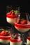 Exposition of fresh organic curd cream and jelly with strawberry on black background.