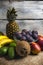 Exposition of fresh organic fruits, mango, bananas, coconut, avocado and fig on white background. Healthy food.