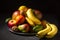 Exposition of fresh organic fruits on plate, orange, mango, banana, apple, kiwi, lemon on black background. Nature and healthy fru