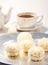 Exposition of sweet chocolate marshmallows with cup of tea on white background